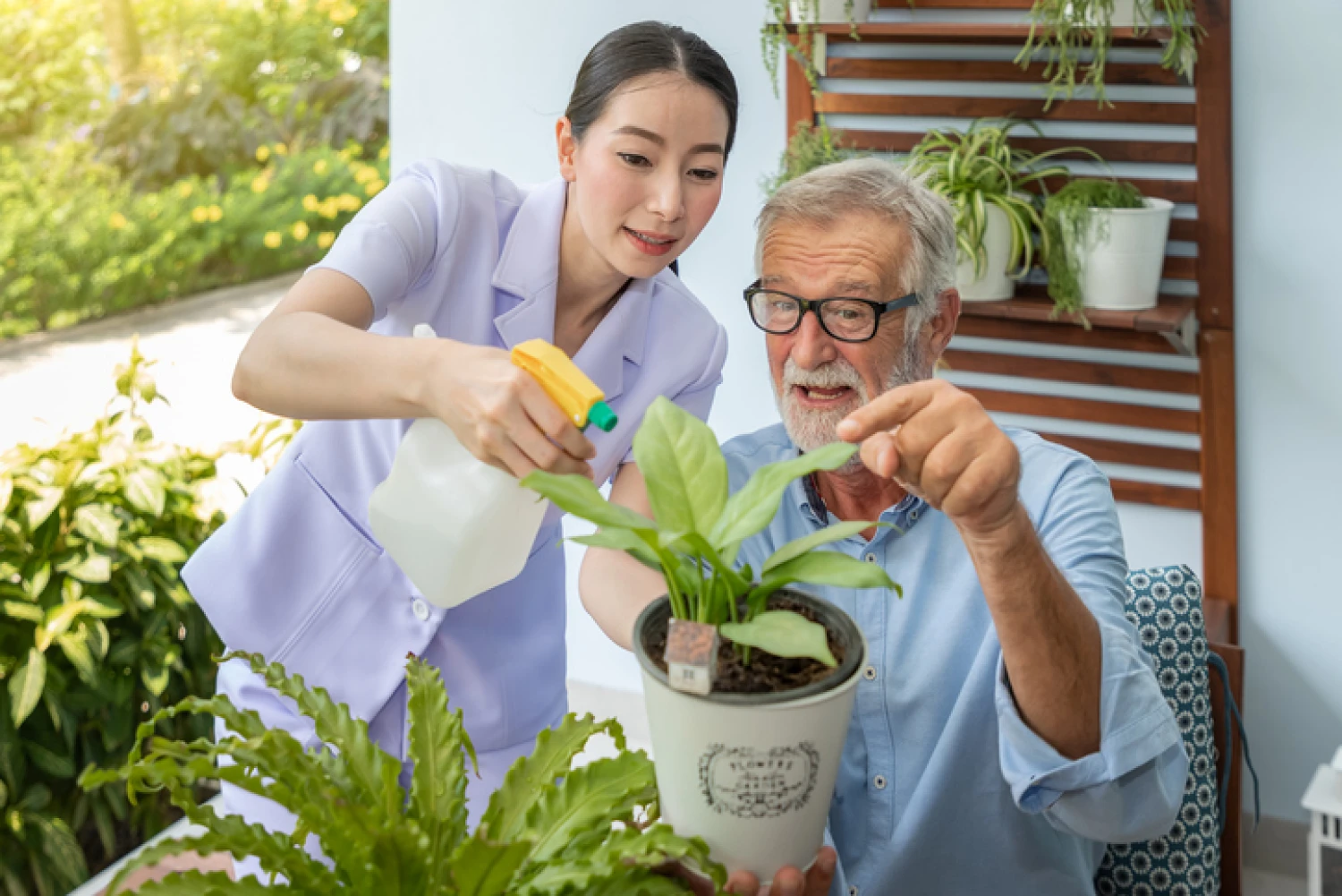Elderly man receiving assistance with gardening from a caregiver, part of a Level 4 home care package.