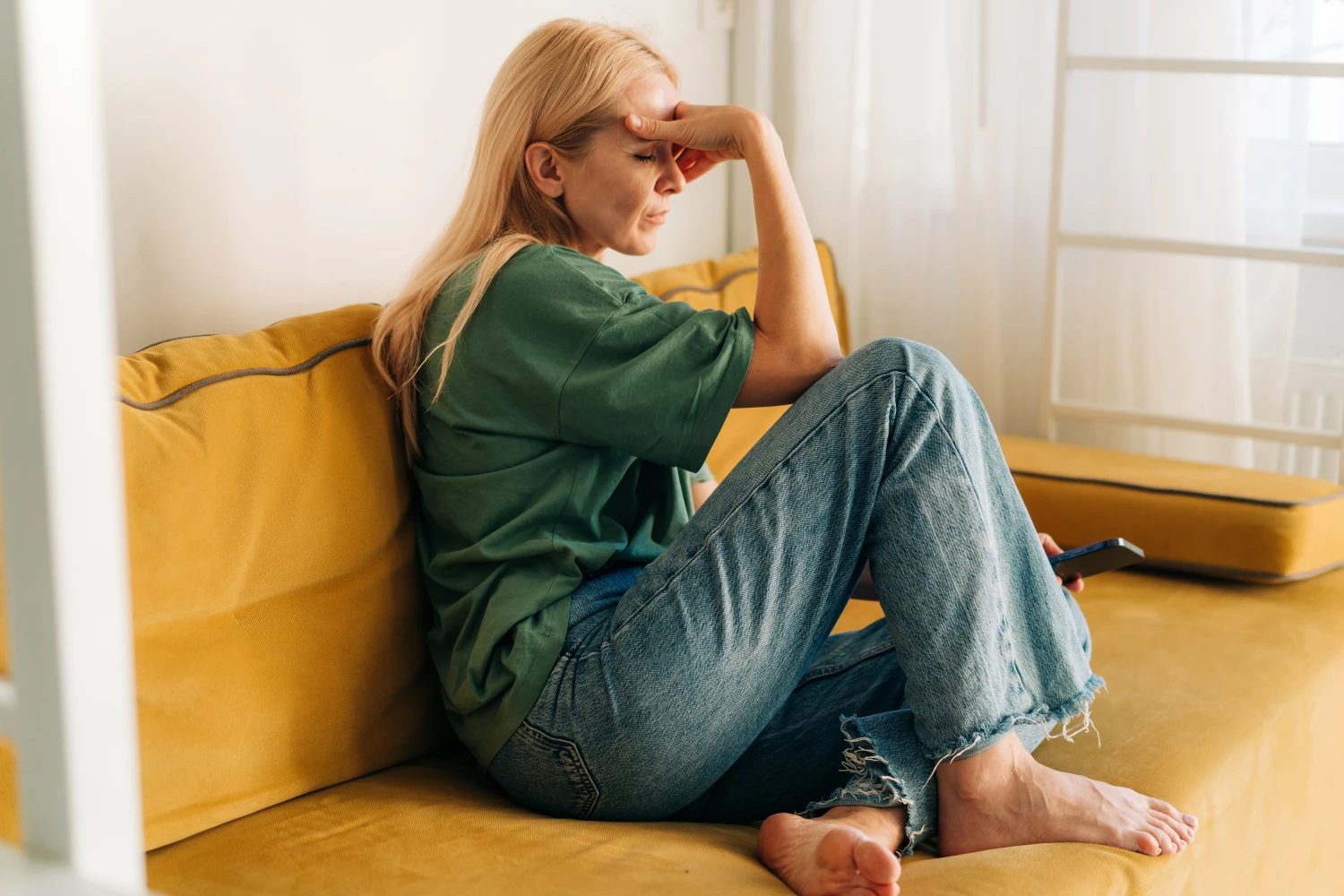 A caregiver experiencing a moment of stress, highlighting the need for the support that respite care services provide.