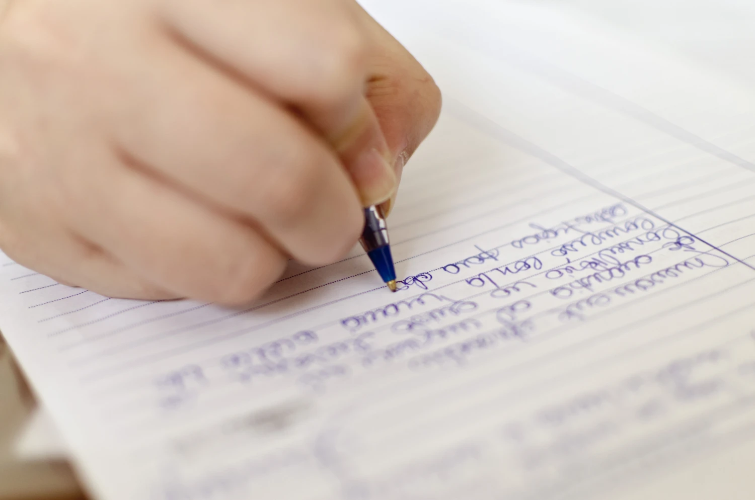 Hand of woman with autism with pen, writing NDIS goals. Focus Care