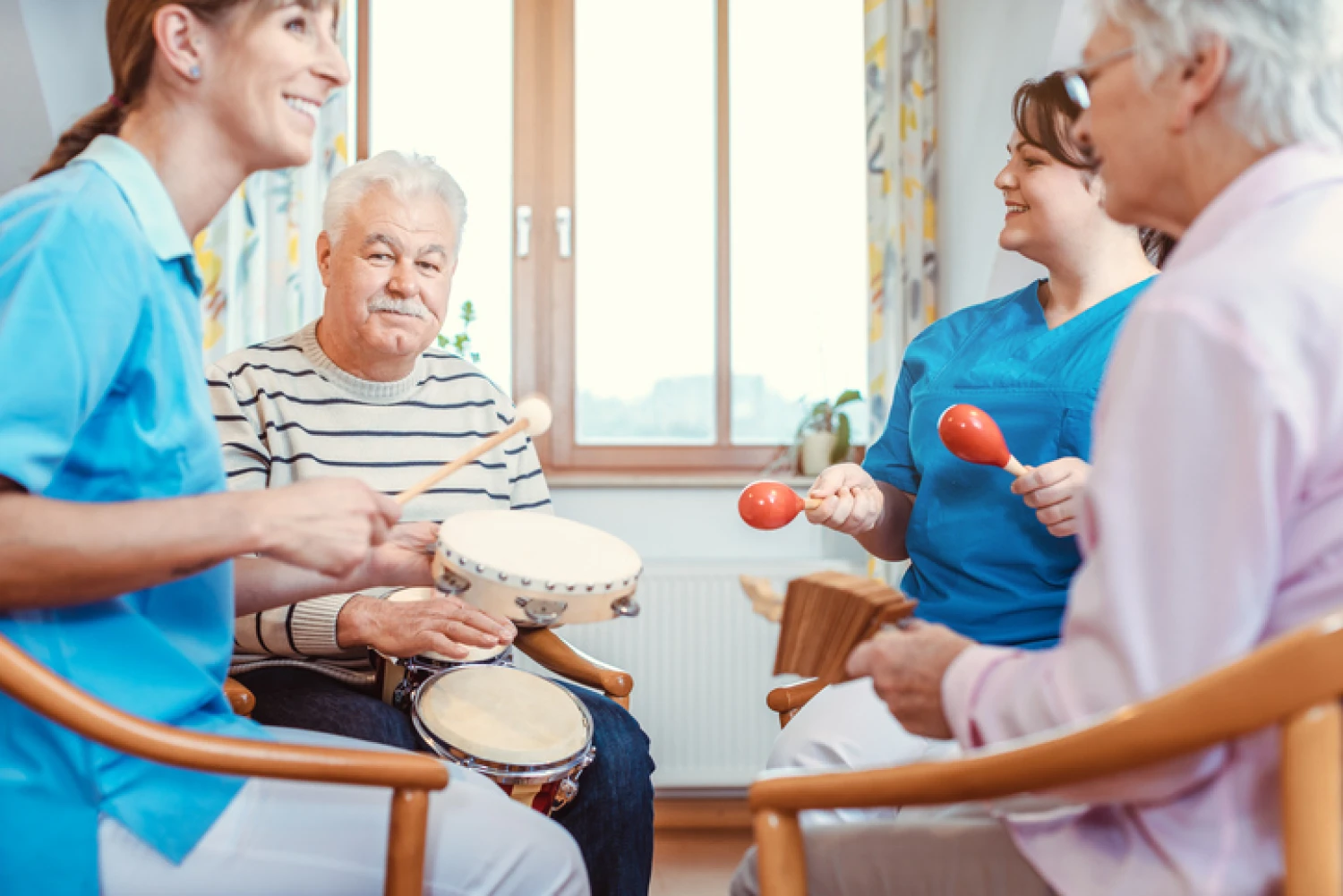 Seniors engaging in group music therapy with percussion instruments.